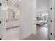 Hallway view of modern bathroom with double sink vanity and sleek fixtures at 4110 W Swann Ave, Tampa, FL 33609