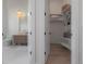 Bright bathroom with a floating vanity and a walk-in closet featuring custom shelving for optimal storage at 4110 W Swann Ave, Tampa, FL 33609