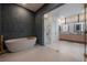 Spa-like bathroom with a soaking tub, walk-in shower, and modern double vanity at 4110 W Swann Ave, Tampa, FL 33609