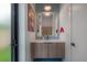 Chic bathroom with modern vanity, stylish mirror, and unique artwork, accented by a pendant light at 4110 W Swann Ave, Tampa, FL 33609