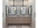 Sleek bathroom vanity with double sinks, marble countertop, and illuminated mirrors at 4110 W Swann Ave, Tampa, FL 33609
