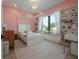 Bright bedroom with a canopy bed, window seat, and built-in bookshelves at 4110 W Swann Ave, Tampa, FL 33609