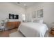 Modern bedroom with a TV, dresser, and minimalist decor at 4110 W Swann Ave, Tampa, FL 33609