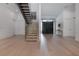Spacious foyer with light wood floors, a modern staircase, and abundant natural light at 4110 W Swann Ave, Tampa, FL 33609