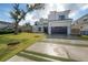 Contemporary home featuring a well-manicured lawn and a modern driveway design at 4110 W Swann Ave, Tampa, FL 33609