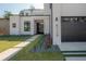Stunning modern home exterior featuring sleek lines, minimalist landscaping, and a contemporary garage door at 4110 W Swann Ave, Tampa, FL 33609