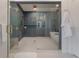 Modern bathroom featuring a frameless glass shower with gold fixtures and subway tile at 4110 W Swann Ave, Tampa, FL 33609