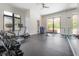 Spacious home gym with large windows, workout equipment, and a mirror wall for a complete fitness experience at 4110 W Swann Ave, Tampa, FL 33609