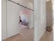 Hallway with barn door leading to a playroom featuring a colorful mural at 4110 W Swann Ave, Tampa, FL 33609