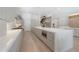 A well-appointed kitchen featuring modern gray cabinetry, an expansive island, and stainless steel appliances at 4110 W Swann Ave, Tampa, FL 33609