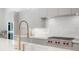 Modern kitchen featuring stainless steel appliances, a stylish faucet, and ample counter space at 4110 W Swann Ave, Tampa, FL 33609