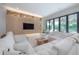 Open living room features modern decor, white sofas and view of the outdoor space at 4110 W Swann Ave, Tampa, FL 33609