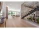 Bright, open-concept living room with a modern staircase and views of the backyard at 4110 W Swann Ave, Tampa, FL 33609