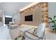 Bright living room features built-in shelving and a large screen TV at 4110 W Swann Ave, Tampa, FL 33609