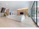 Bright living room with a large sectional sofa, custom shelving, and floor-to-ceiling windows at 4110 W Swann Ave, Tampa, FL 33609