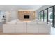 Bright living room showcasing a large sofa, accent wall, and a seamless indoor-outdoor flow at 4110 W Swann Ave, Tampa, FL 33609