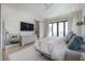 Elegant main bedroom with a view of the balcony, light wood floors and white walls at 4110 W Swann Ave, Tampa, FL 33609
