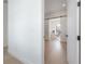 View of the office space with barn door, hardwood floors, and bright light fixture at 4110 W Swann Ave, Tampa, FL 33609