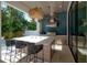 Elegant outdoor kitchen with an island, bar seating, and stainless steel appliances with pool at 4110 W Swann Ave, Tampa, FL 33609