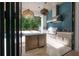 Modern outdoor kitchen with stainless steel appliances and ample counter space overlooking pool at 4110 W Swann Ave, Tampa, FL 33609