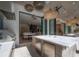 View of outdoor kitchen and dining area with stainless appliances, overlooking a pool and backyard at 4110 W Swann Ave, Tampa, FL 33609