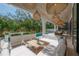 Inviting outdoor living space with comfortable seating, dining area, and lush landscaping by the pool at 4110 W Swann Ave, Tampa, FL 33609