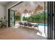Covered patio with outdoor dining set, wicker pendant lights, and sliding glass doors at 4110 W Swann Ave, Tampa, FL 33609