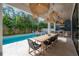Large outdoor patio with dining, outdoor kitchen, and a large inground pool at 4110 W Swann Ave, Tampa, FL 33609
