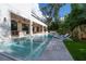 Beautiful pool area with an outdoor kitchen, lounge chairs, and lush landscaping at 4110 W Swann Ave, Tampa, FL 33609