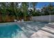 Beautiful pool with sun loungers surrounded by lush tropical landscaping for privacy at 4110 W Swann Ave, Tampa, FL 33609