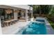 Inviting outdoor space featuring a pristine pool, an outdoor dining area and a bar at 4110 W Swann Ave, Tampa, FL 33609