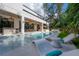 Luxurious backyard pool with an outdoor dining area and elegant lounge furniture at 4110 W Swann Ave, Tampa, FL 33609