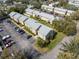 Aerial view of multi-unit buildings with ample parking, green space, and mature trees at 4215 E Bay Dr # 1601D, Clearwater, FL 33764