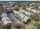 Aerial view of condo community featuring assigned parking, mature trees, and convenient city access at 4215 E Bay Dr # 1601D, Clearwater, FL 33764