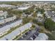 Aerial view of condo community featuring assigned parking, mature trees, and convenient city access at 4215 E Bay Dr # 1601D, Clearwater, FL 33764