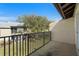 Outdoor patio with an iron railing and a view of a grassy area with large oak trees at 4215 E Bay Dr # 1601D, Clearwater, FL 33764