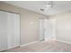 Neutral bedroom with a ceiling fan and two closets with bi-fold doors at 4215 E Bay Dr # 1601D, Clearwater, FL 33764