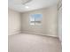 Bedroom with carpet flooring, a ceiling fan, and a large window with plantation shutters at 4215 E Bay Dr # 1601D, Clearwater, FL 33764