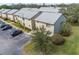An aerial view of two story condo buildings with a parking lot and lush landscaping at 4215 E Bay Dr # 1601D, Clearwater, FL 33764