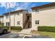 Exterior view of the two-story condo building featuring a staircase and well-maintained landscaping at 4215 E Bay Dr # 1601D, Clearwater, FL 33764