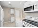 Bright kitchen with white cabinets and appliances, offering a clean and modern feel at 4215 E Bay Dr # 1601D, Clearwater, FL 33764