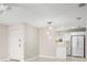 Open-concept living space with pendant lighting and view of kitchen featuring white appliances at 4215 E Bay Dr # 1601D, Clearwater, FL 33764
