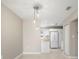 Open-concept living area with pendant lighting and view of kitchen with white appliances at 4215 E Bay Dr # 1601D, Clearwater, FL 33764