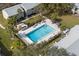 Aerial view of a community pool with lounge chairs and tables for residents at 4215 E Bay Dr # 1601D, Clearwater, FL 33764