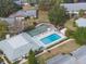 Aerial view of a community pool, shuffleboard and lounge chairs with tables at 4215 E Bay Dr # 1601D, Clearwater, FL 33764