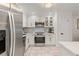 Modern kitchen with stainless appliances, white cabinets, and marble tile flooring at 4400 37Th S St # 3, St Petersburg, FL 33711