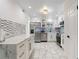 Bright kitchen features stainless steel appliances, white cabinets, gold hardware, and stylish marble countertops at 4400 37Th S St # 3, St Petersburg, FL 33711