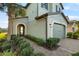 Inviting home exterior with a brick-paved walkway, lush greenery, and a well-maintained two-car garage at 4739 Tramanto Ln, Wesley Chapel, FL 33543