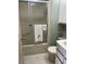 Functional bathroom with a shower/tub combination and neutral tiling at 4845 Baker Ave, Zephyrhills, FL 33541