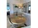 Cozy dining area with a round table, chairs, and decorative mirrors at 4845 Baker Ave, Zephyrhills, FL 33541